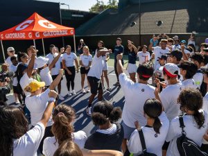 Kids celebrating on tennis court with Gatorade tent.