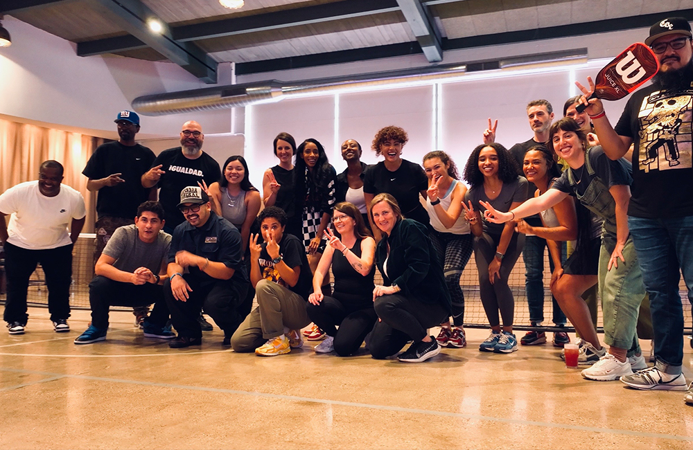 ourservices-privatepickleballevents Group photo on a pickleball court.